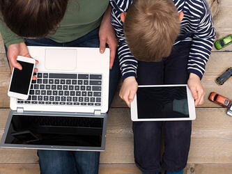 Child and parent using digital technology
